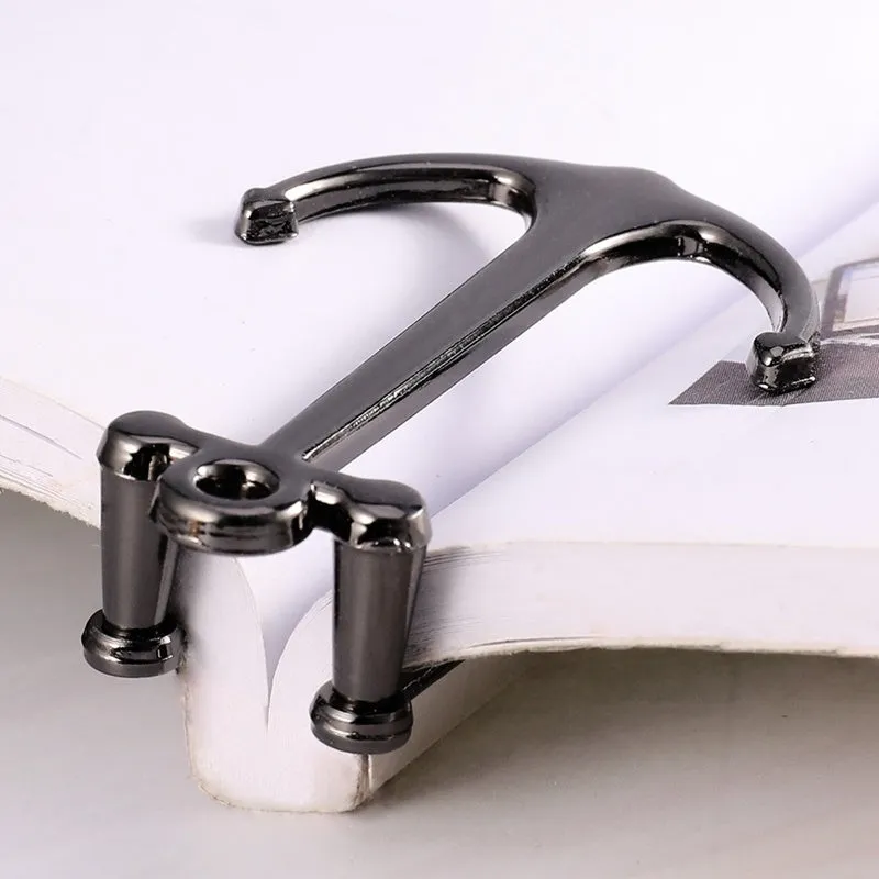 Creative metal bookmark page folder in silver colour, 1.78 x 6.6 cm, on an open book