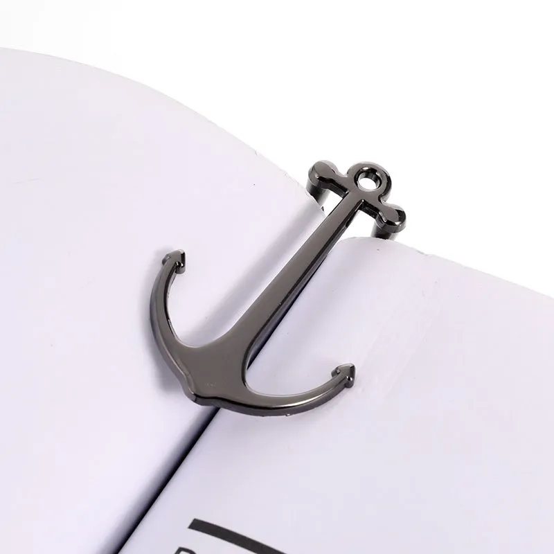 Creative metal bookmark page folder in silver colour, 1.78 x 6.6 cm, on an open book