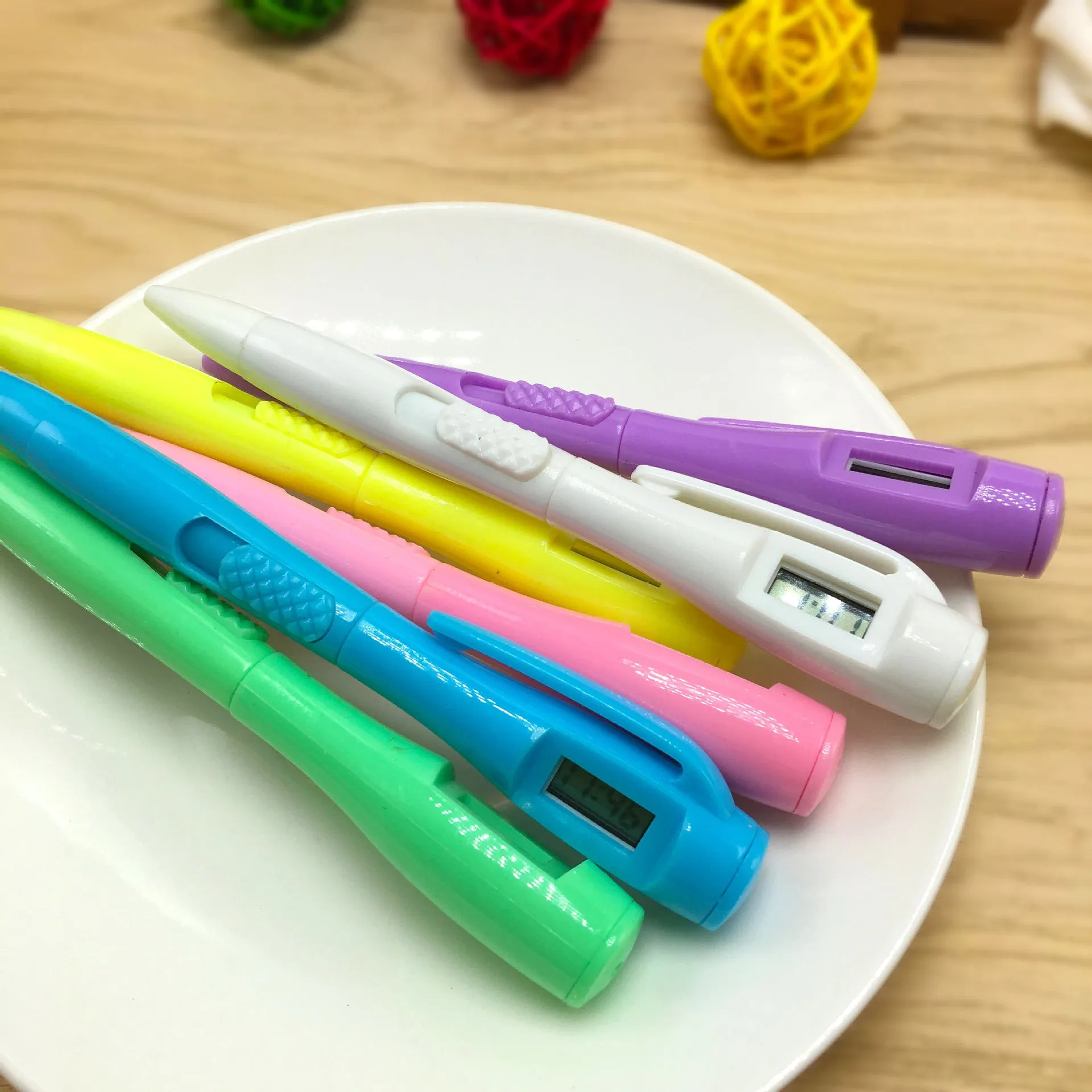 Electronic watch test ballpoint pen with plastic shell in a colour option, on a plain background