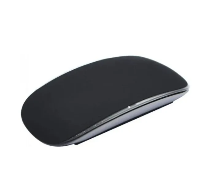 Silicone Magic Mouse cover skin in black on a white desk next to an Apple Magic Mouse