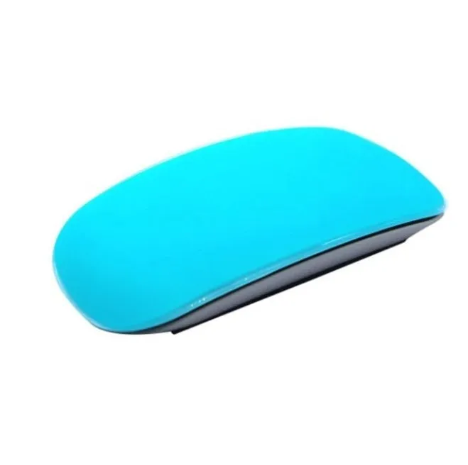 Silicone Magic Mouse cover skin in black on a white desk next to an Apple Magic Mouse