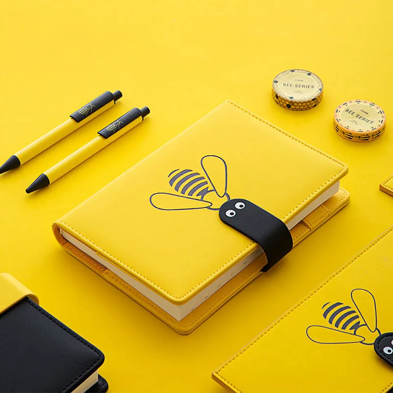 Open B6 notebook with 144 sheets, black PU cover, on a wooden desk