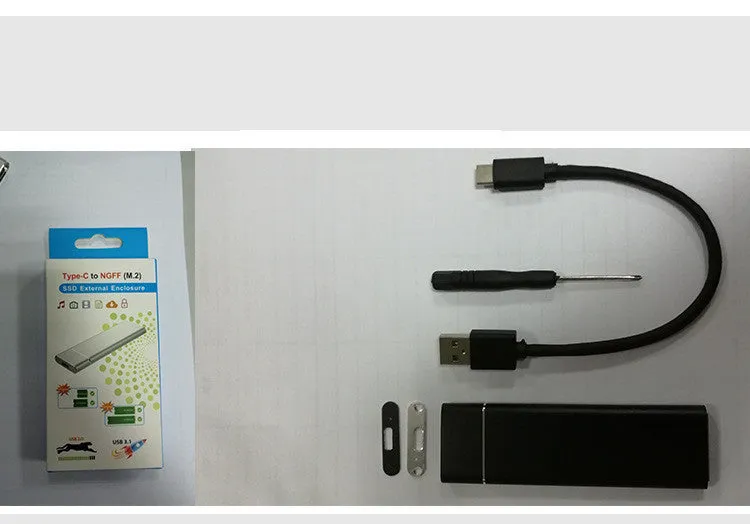 Silver aluminium alloy M.2 NGFF to USB 3.1 SSD mobile hard disk enclosure on a wooden desk