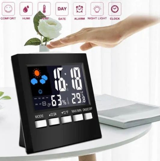 Black multifunctional perpetual calendar clock with alarm, weather forecast, thermometer, and blue backlight on a desk