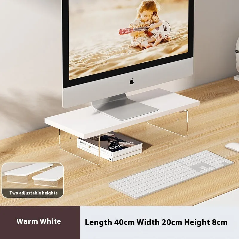 Black computer riser with acrylic legs on desk under monitor
