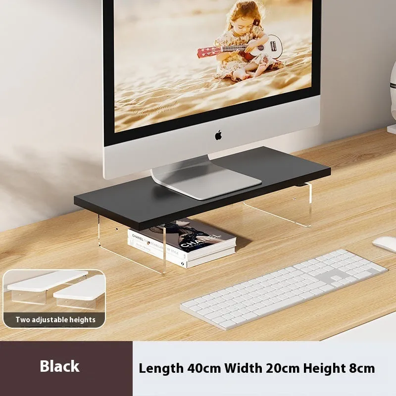 Black computer riser with acrylic legs on desk under monitor