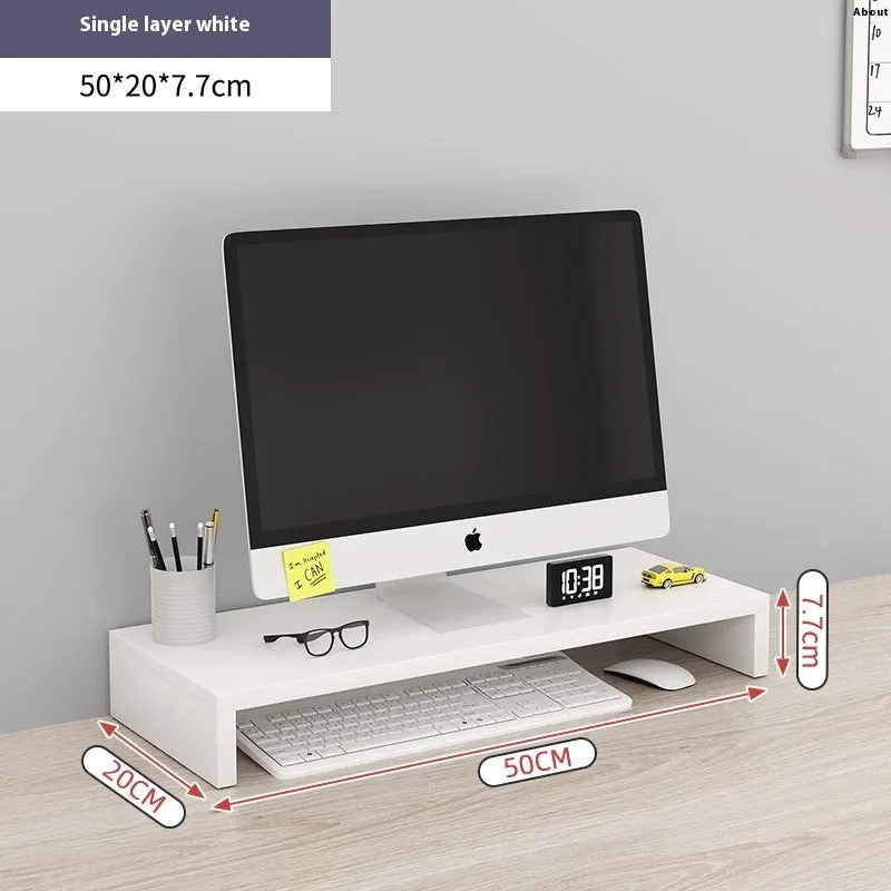 Black computer riser with acrylic legs on desk under monitor
