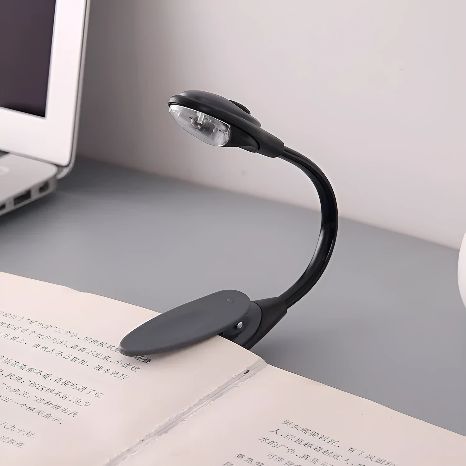 Black clip-on LED book light with gooseneck arm and small LED head, 26cm total length