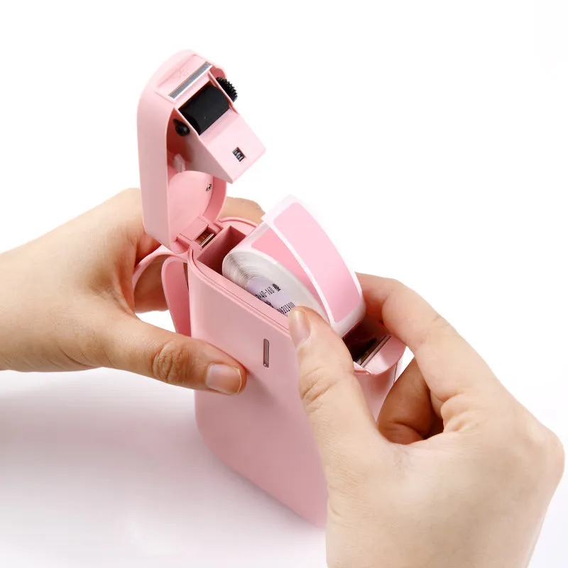 D11 Bluetooth label printer in black with thermal paper roll and smartphone showing app interface