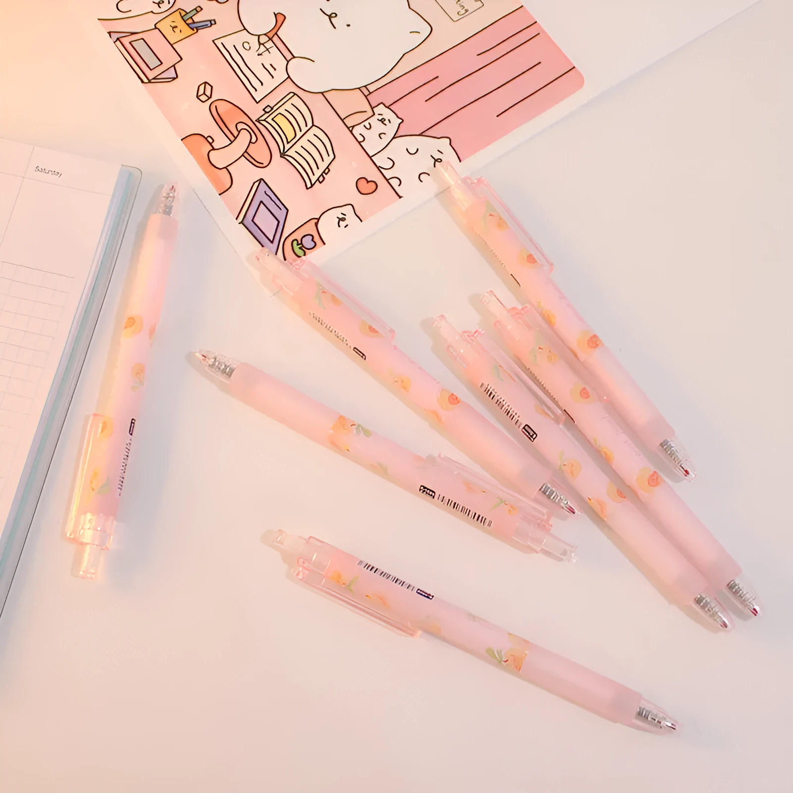 Cute Peach press gel pen with 14cm plastic body and rollerball tip against white background
