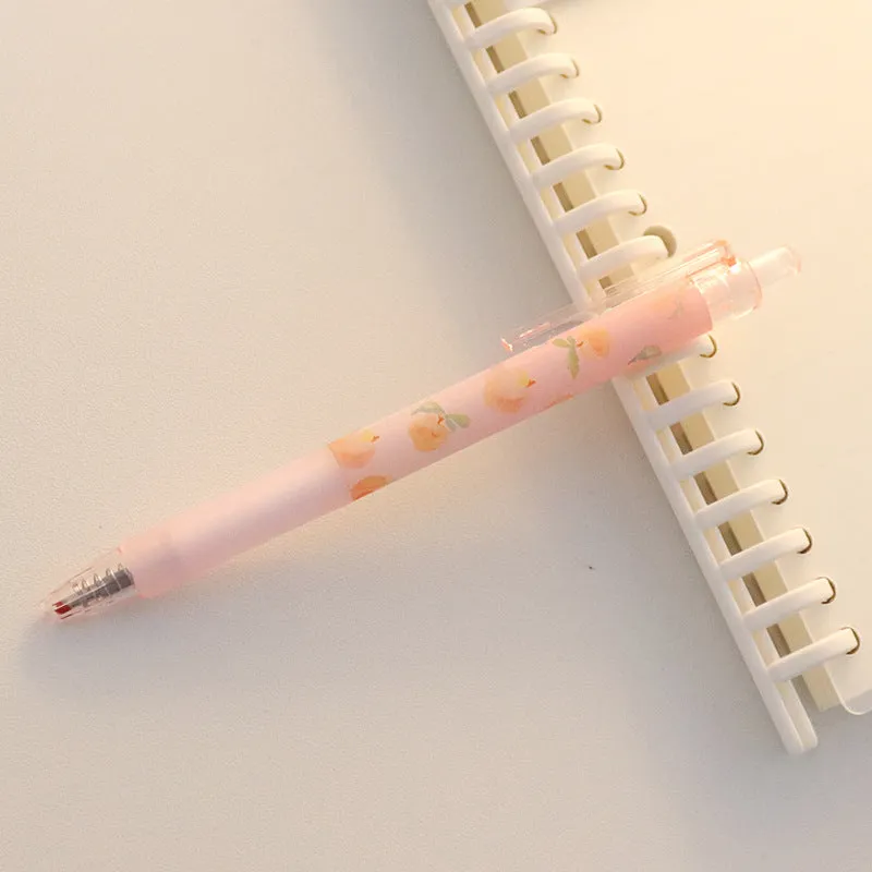Cute Peach press gel pen with 14cm plastic body and rollerball tip against white background