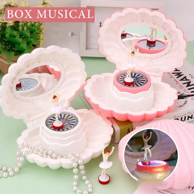 Plastic ballet girl music box in random colour, shows figure above shell, 160x130x155mm