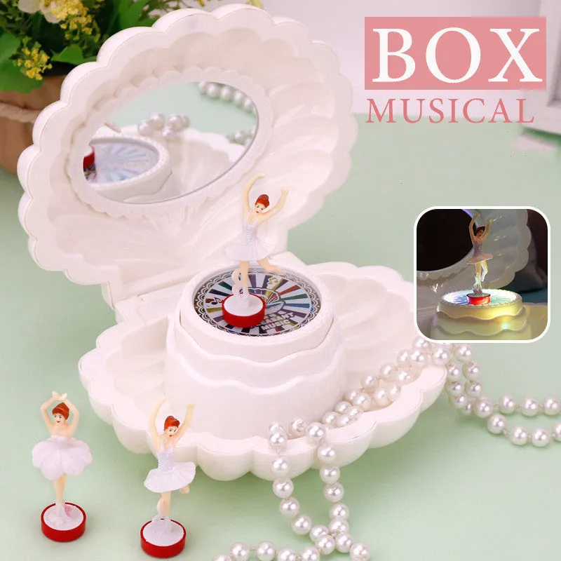Plastic ballet girl music box in random colour, shows figure above shell, 160x130x155mm