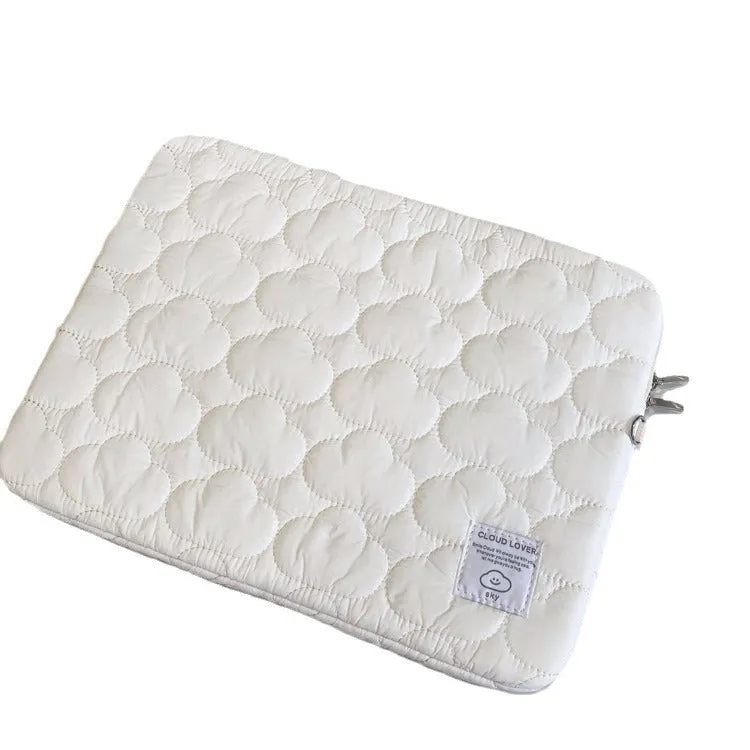 White cotton notebook storage bag with blue cloud embroidery on a table