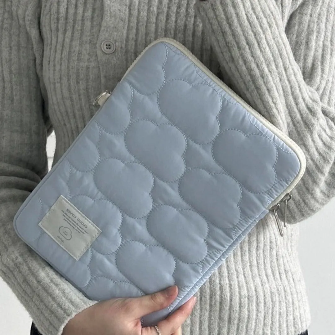 White cotton notebook storage bag with blue cloud embroidery on a table