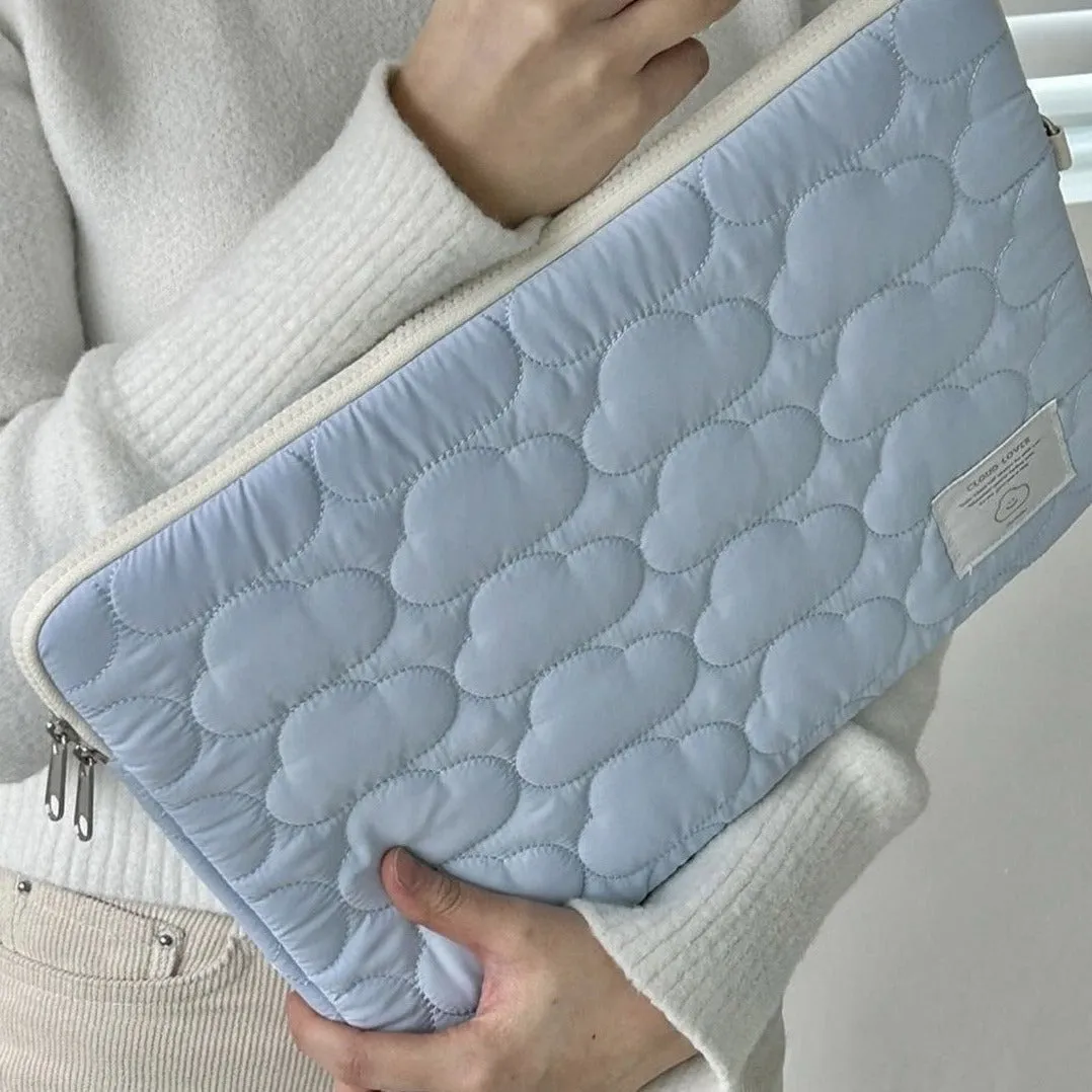 White cotton notebook storage bag with blue cloud embroidery on a table