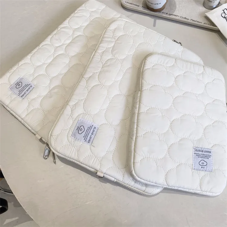 White cotton notebook storage bag with blue cloud embroidery on a table