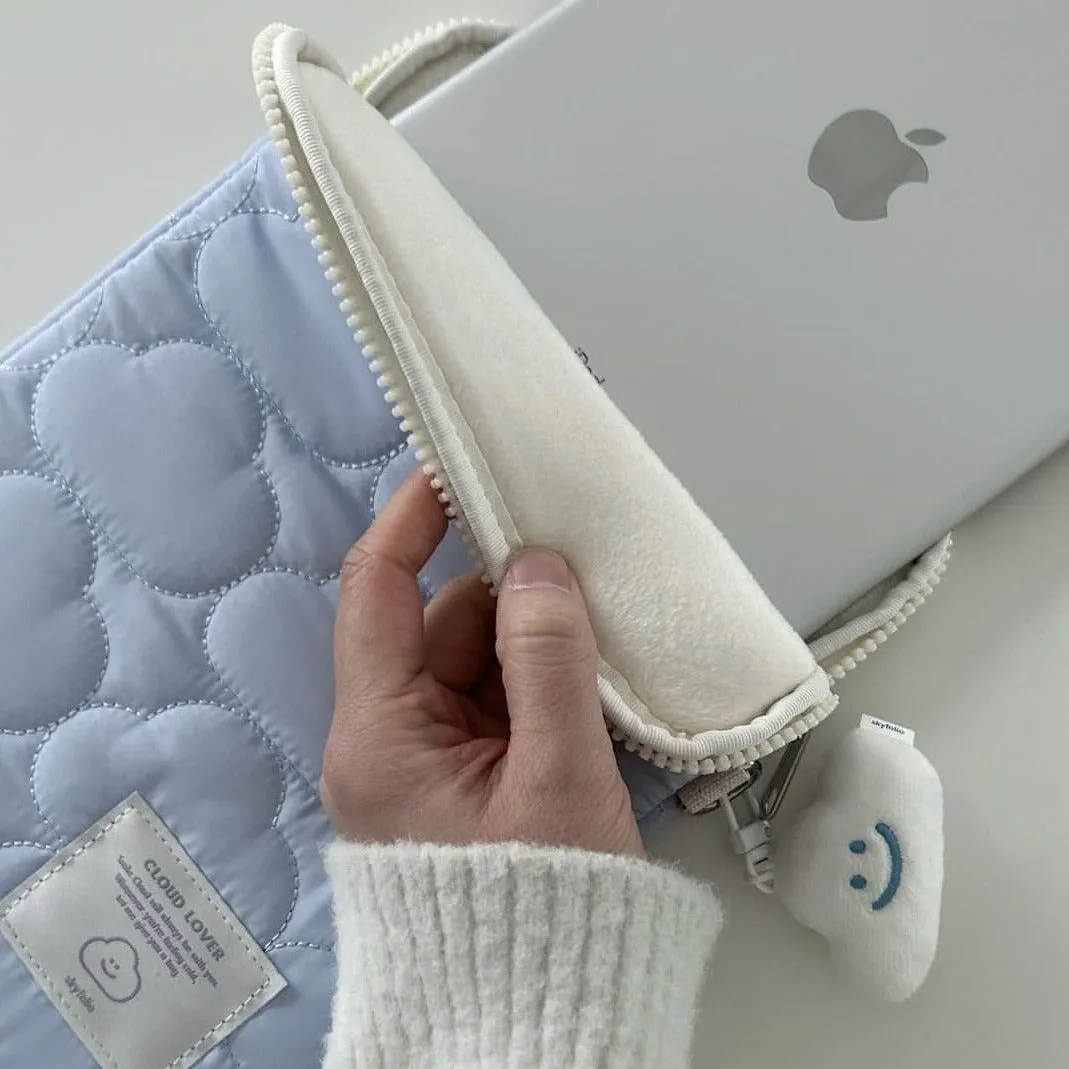 White cotton notebook storage bag with blue cloud embroidery on a table