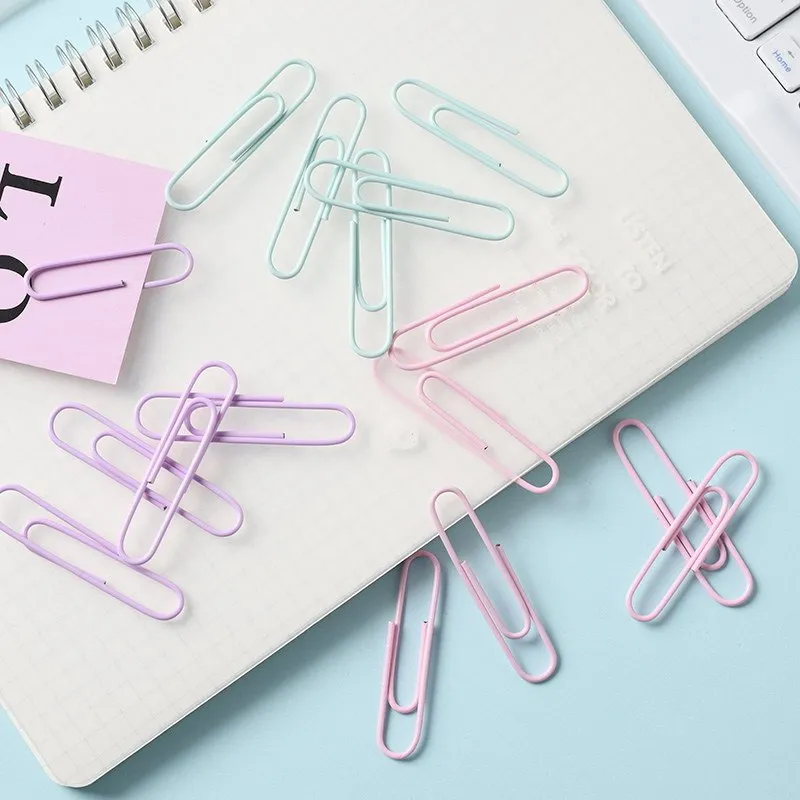 Set of macaron colour alloy paper clips in pink, green, and purple, showing 28mm and 50mm sizes, on a light background
