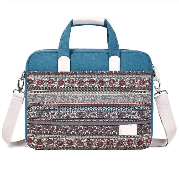 Ethnic style canvas laptop bag in lake blue with zippered front pocket on a table