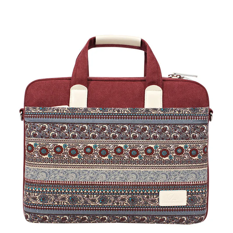 Ethnic style canvas laptop bag in lake blue with zippered front pocket on a table