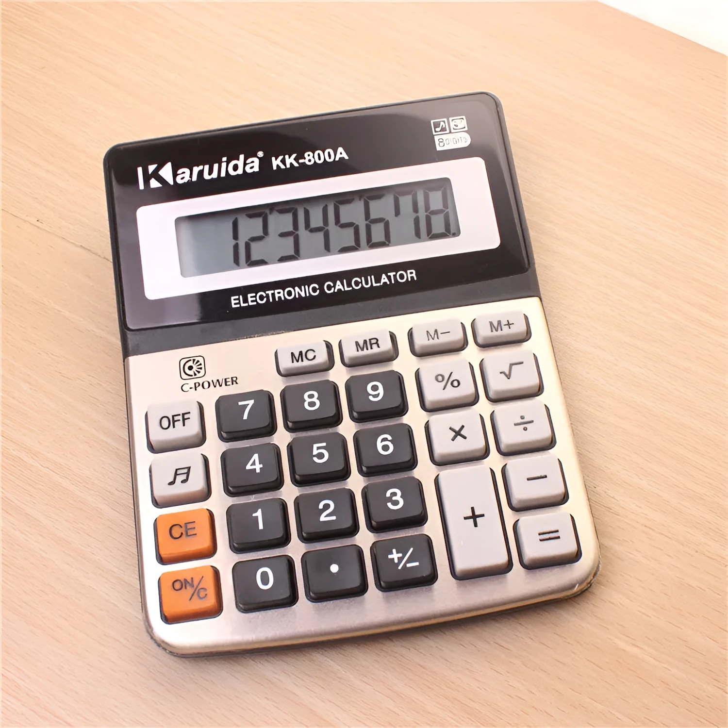Silver aluminium desktop calculator with compact dimensions approximately 14.5 x 11 x 2.5 cm on a desk