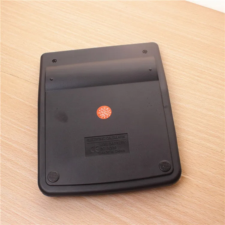 Silver aluminium desktop calculator with compact dimensions approximately 14.5 x 11 x 2.5 cm on a desk