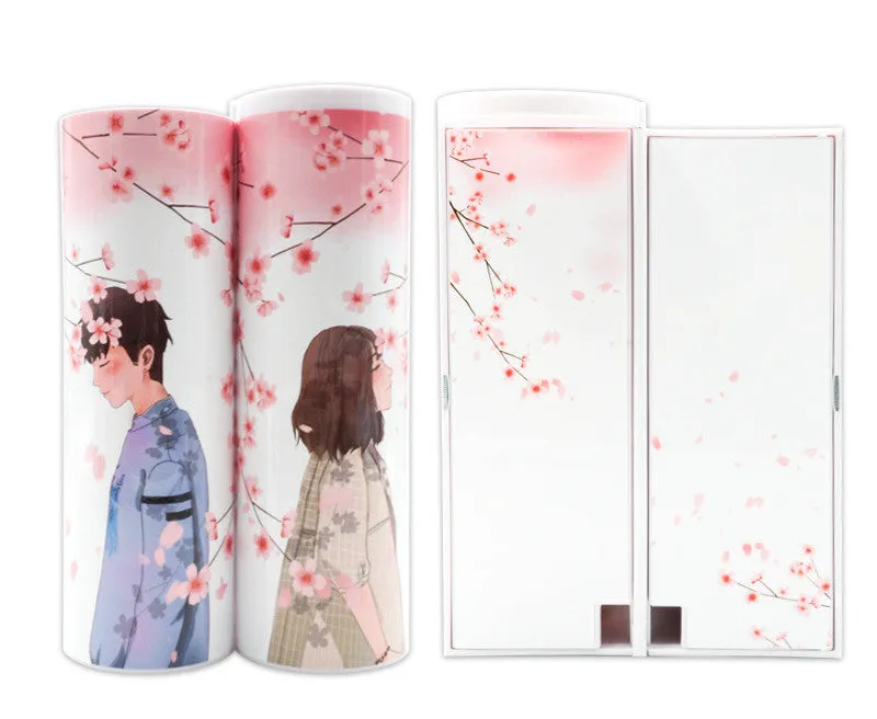 Long double-layer plastic pencil case in a colour variant, shown with stationery items inside, on a plain background