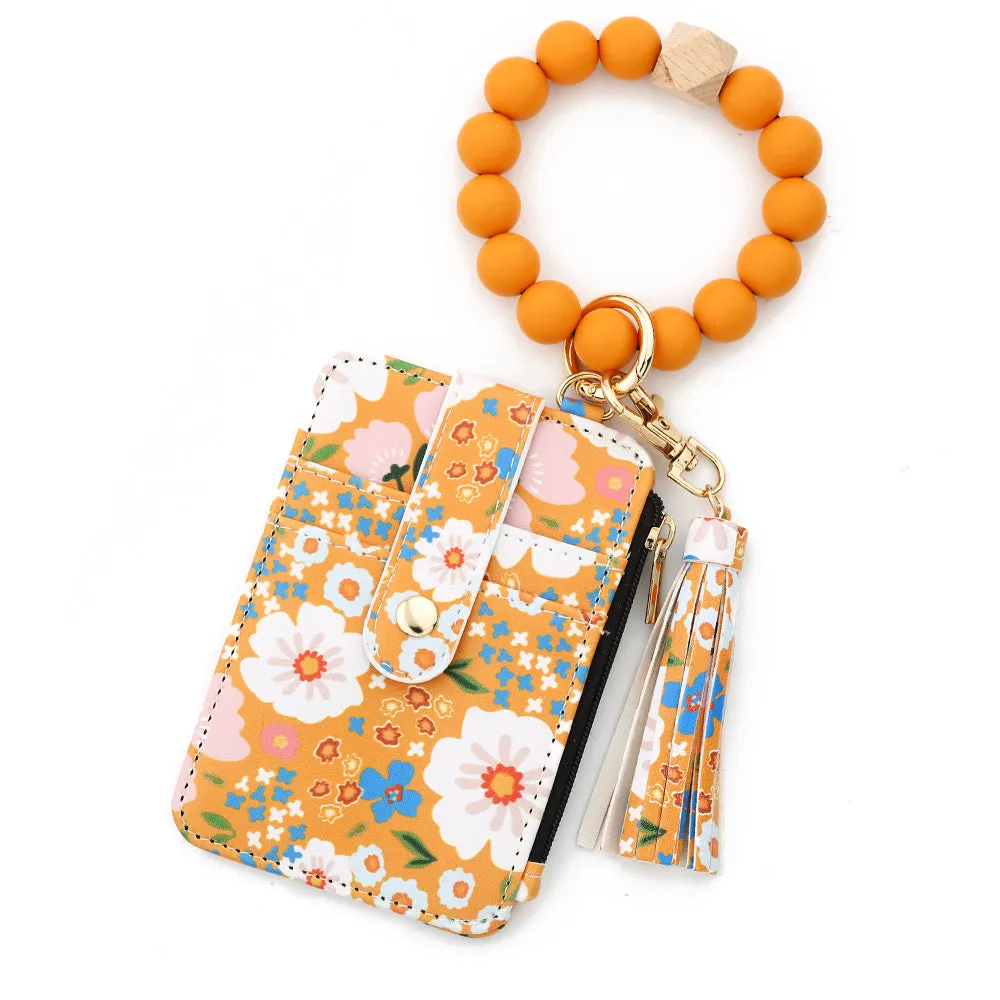 Women's floral print leather card bag in light pink, compact size, on plain background