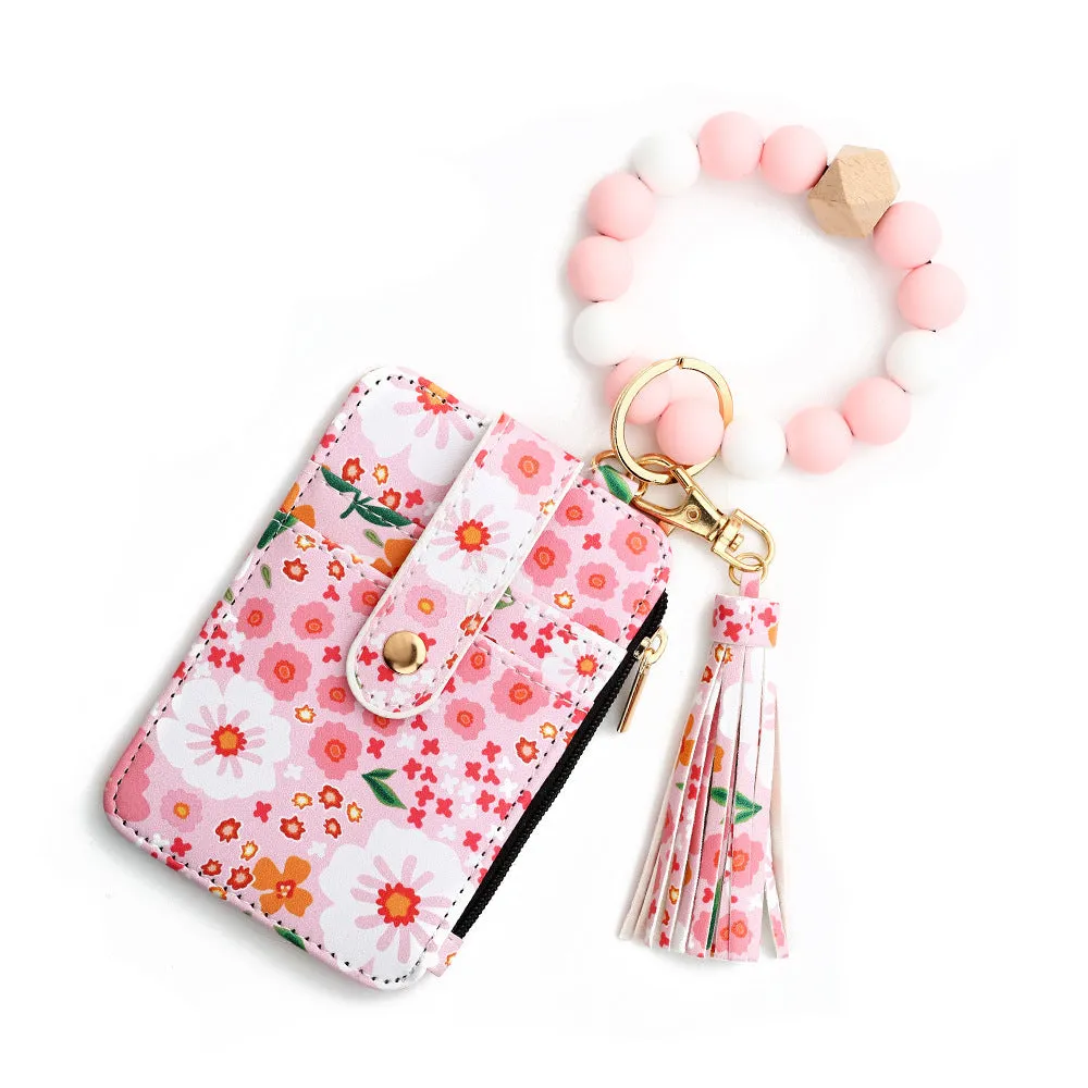 Women's floral print leather card bag in light pink, compact size, on plain background
