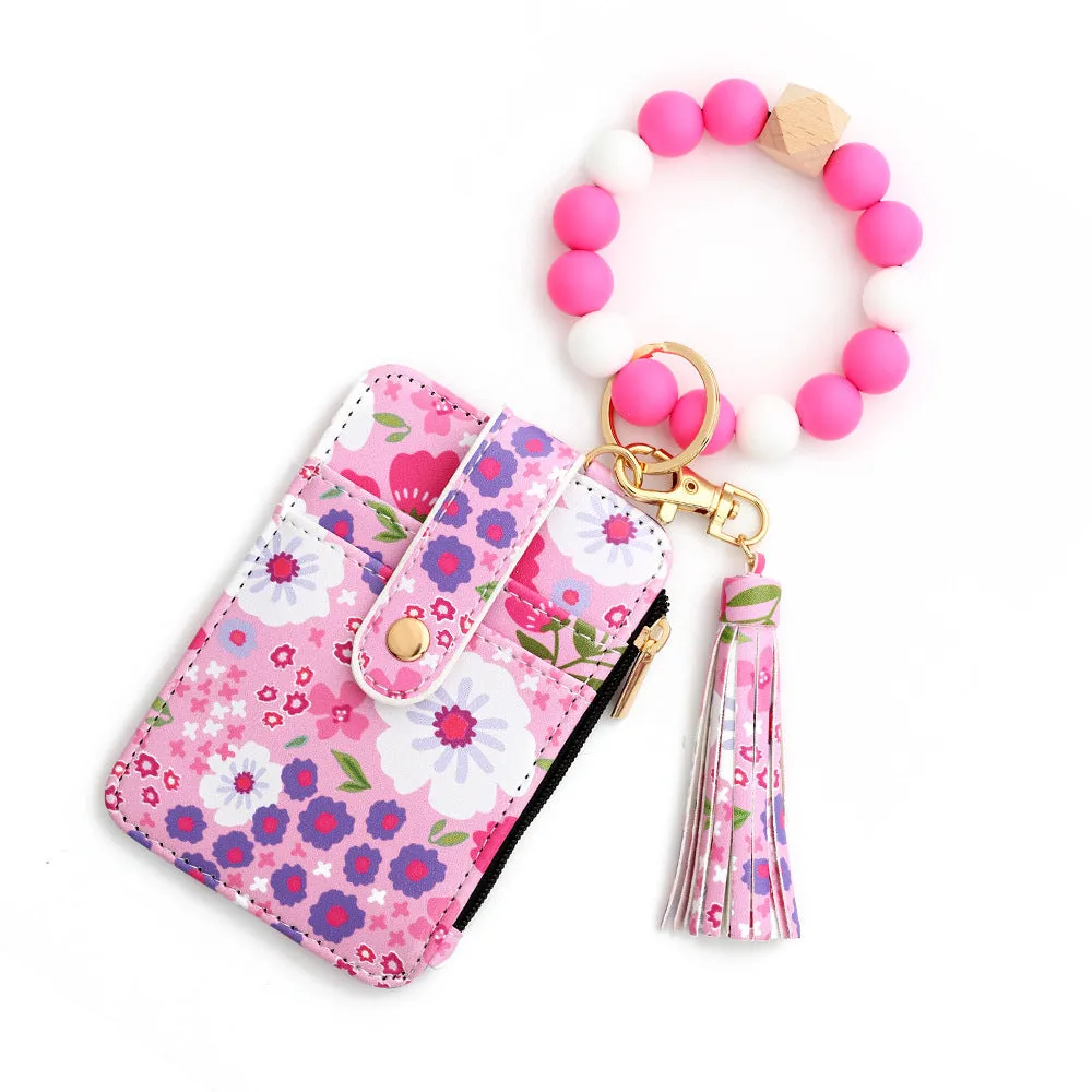 Women's floral print leather card bag in light pink, compact size, on plain background