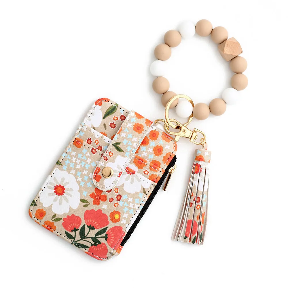 Women's floral print leather card bag in light pink, compact size, on plain background