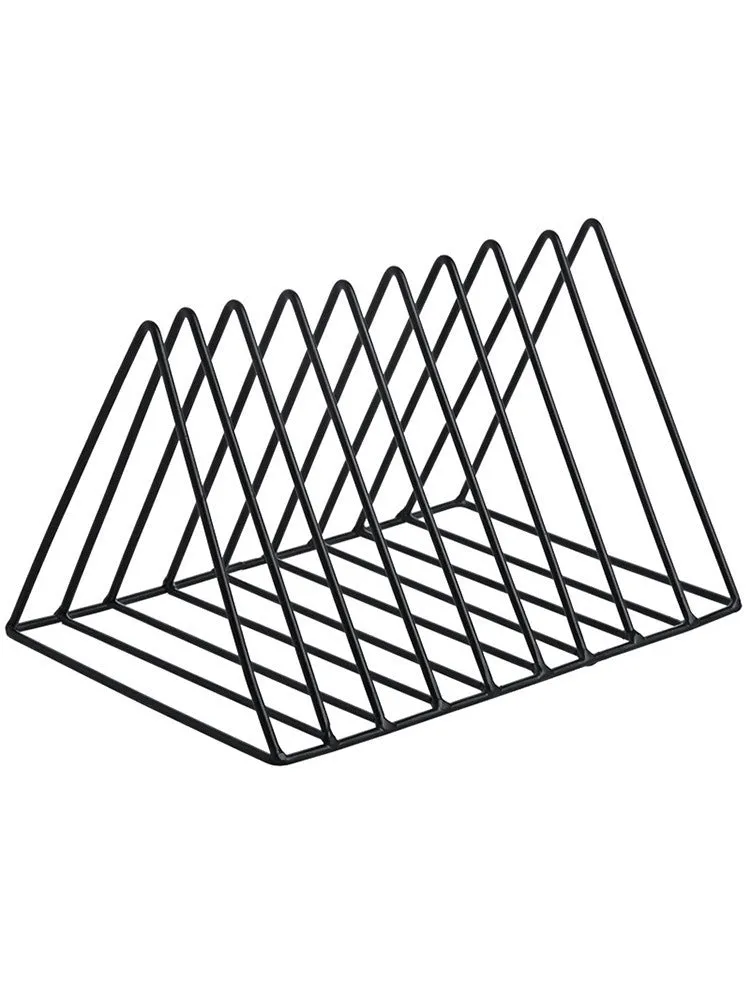 Wrought iron triangle book stand in black on a desk holding a book upright