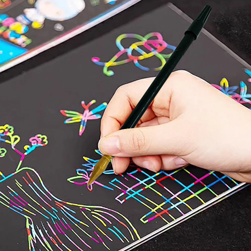 A white PS plastic scratch pen for children's rainbow drawing and art projects on black paper.