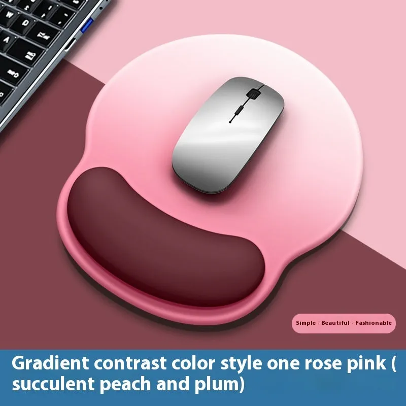 Silicone mouse mat with wrist support in a gradient blue colour on a desk.