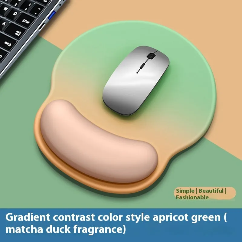 Silicone mouse mat with wrist support in a gradient blue colour on a desk.