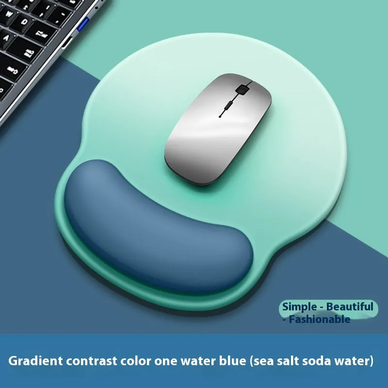 Silicone mouse mat with wrist support in a gradient blue colour on a desk.