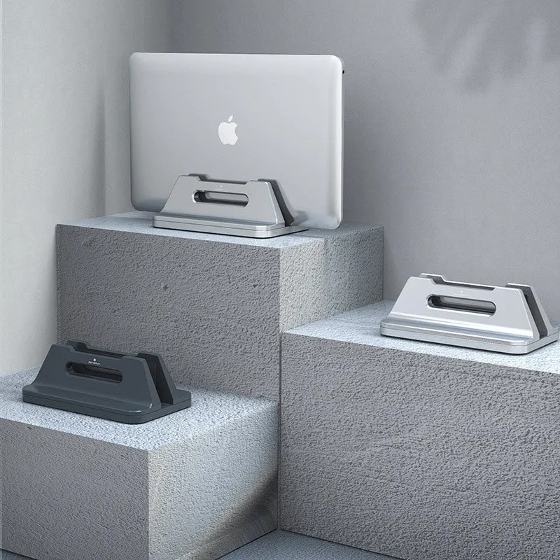 Silver aluminium alloy vertical notebook storage bracket on desk holding a laptop upright