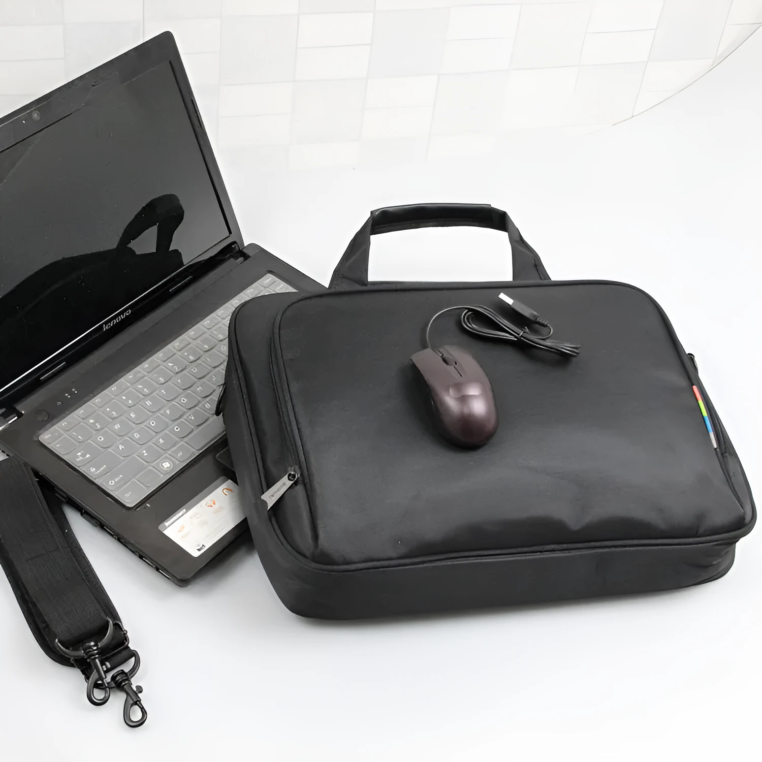 Black one-shoulder nylon computer bag with water repellent finish and hidden non-slip strap for 14-inch laptops