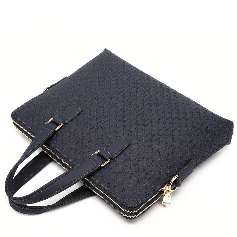 Genuine leather men's business handbag in blue with embossed geometric pattern, soft handles, and zipper closure, designed for a 14-inch laptop