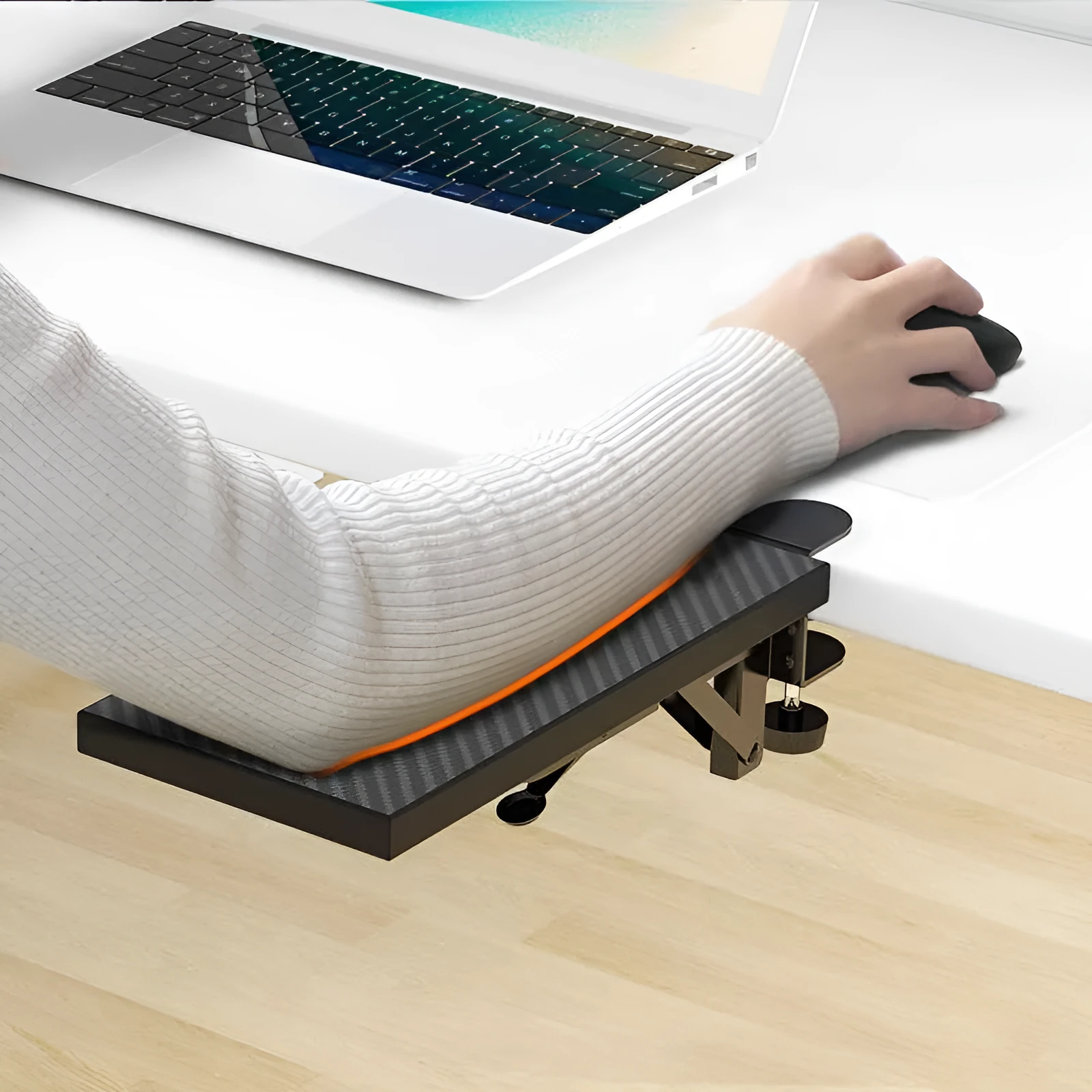 Ergonomic hand bracket in black carbon fiber veneer on a desk for arm support during computer use