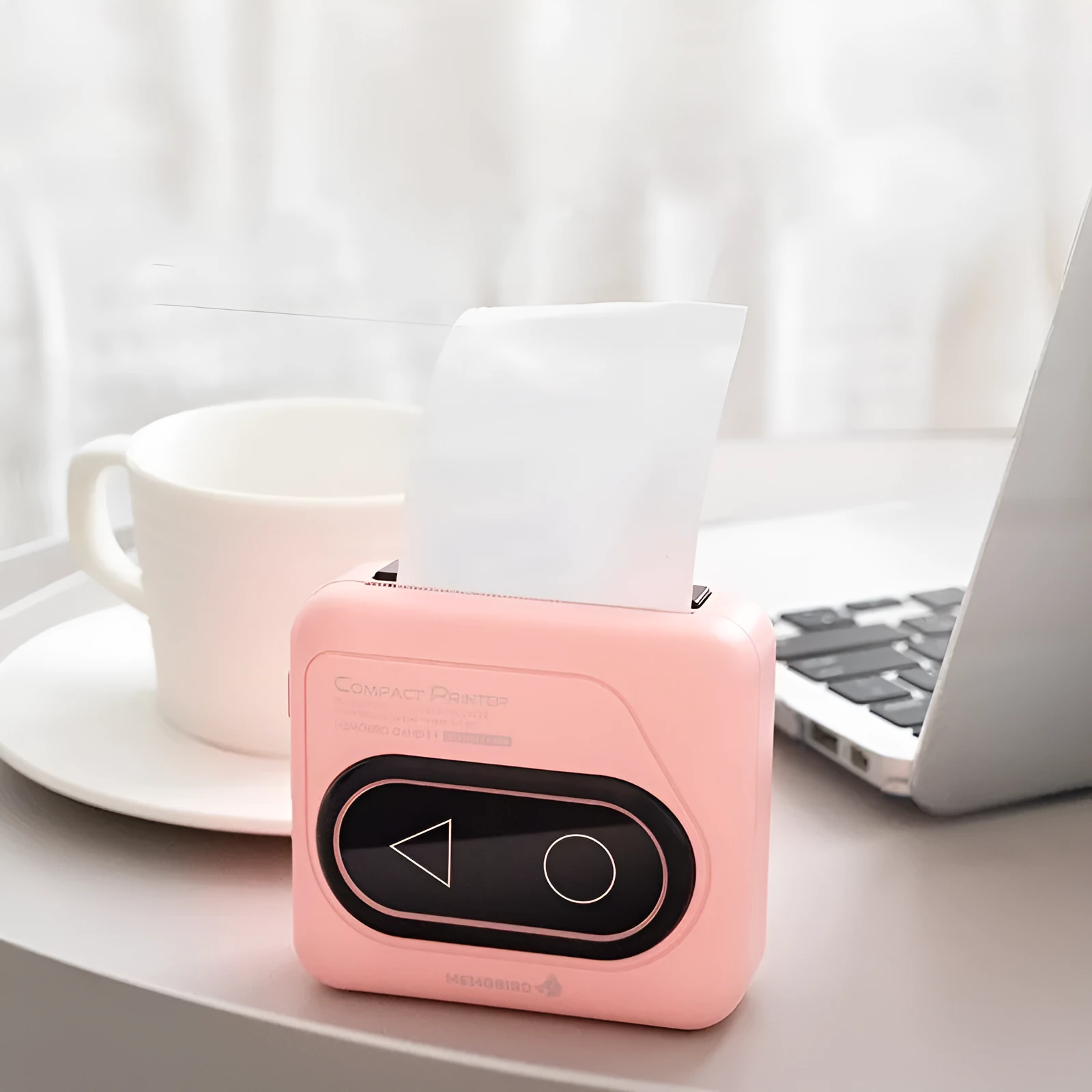 Avocado Green coloured pocket-sized Bluetooth thermal mini printer next to a mobile phone.