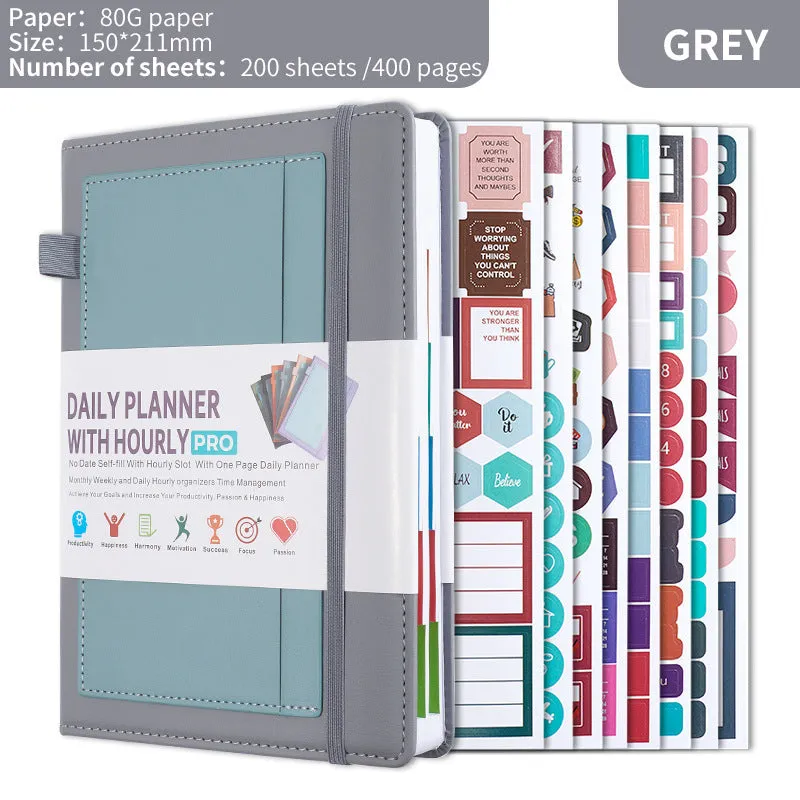 A5 notebook with PU leather cover in various colours, shown open to reveal blank pages and planning stickers.