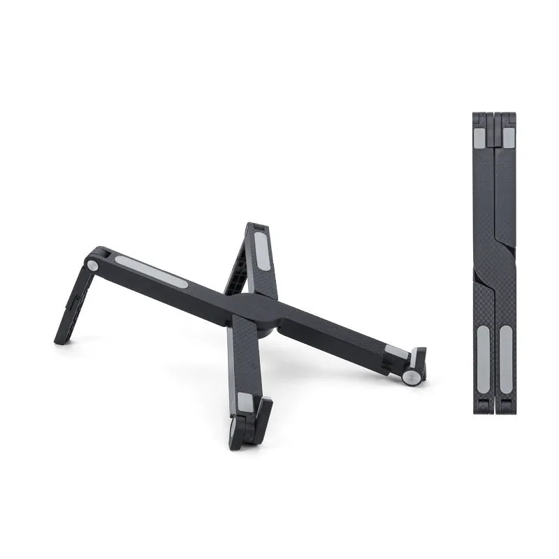 Folding aluminium alloy laptop stand in grey on a wooden desk, showing adjustable width and non-slip pads