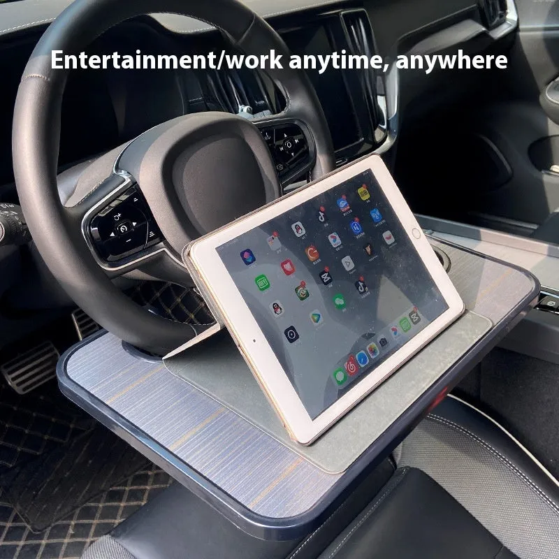 Foldable black car laptop table with built-in cup holder mounted on steering wheel