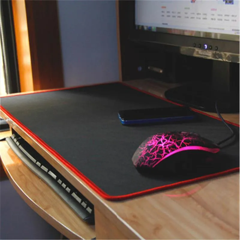 Oversized rubber mouse pad 30x60cm in black with stitched edges for PC laptop use.