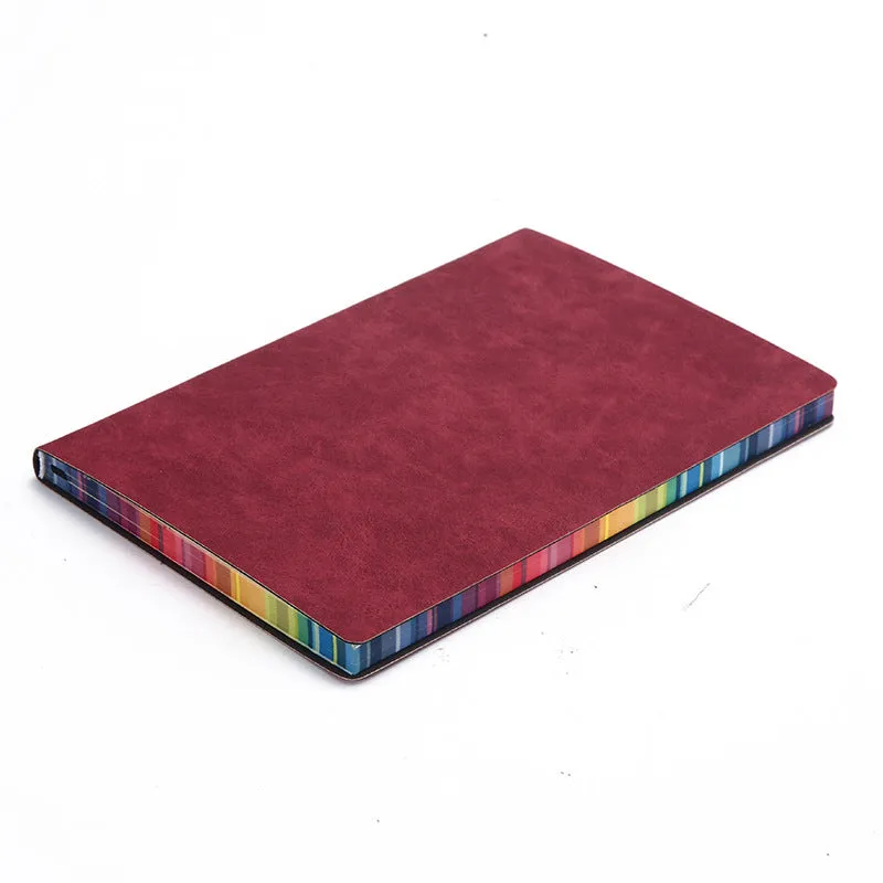 A5 rainbow side PU leather cover notebook open on a desk, showing lock line hardcover binding and 100g Daolin paper pages