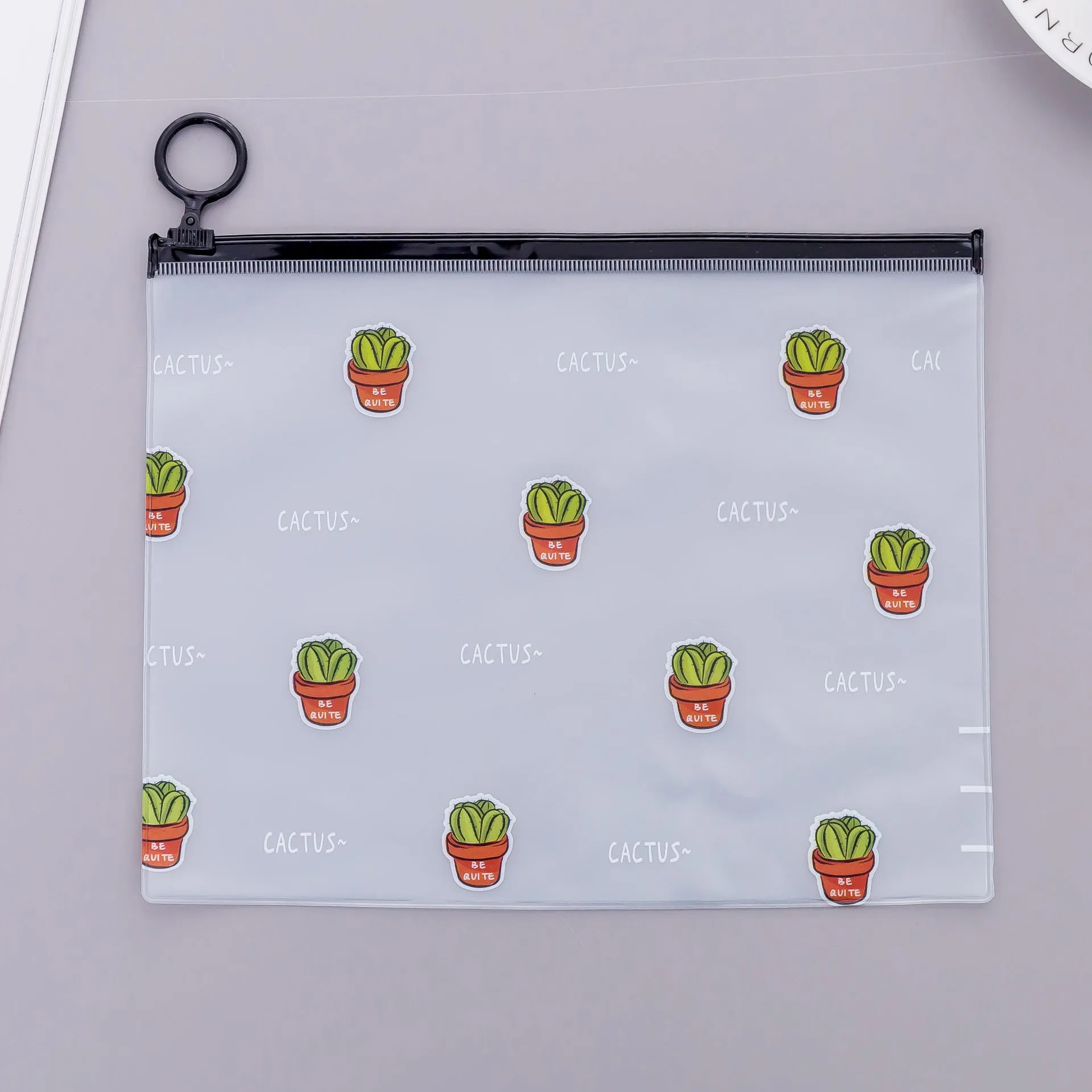PVC pencil case with sealed closure, cactus print, 17.1x21.2cm, on a desk with stationery