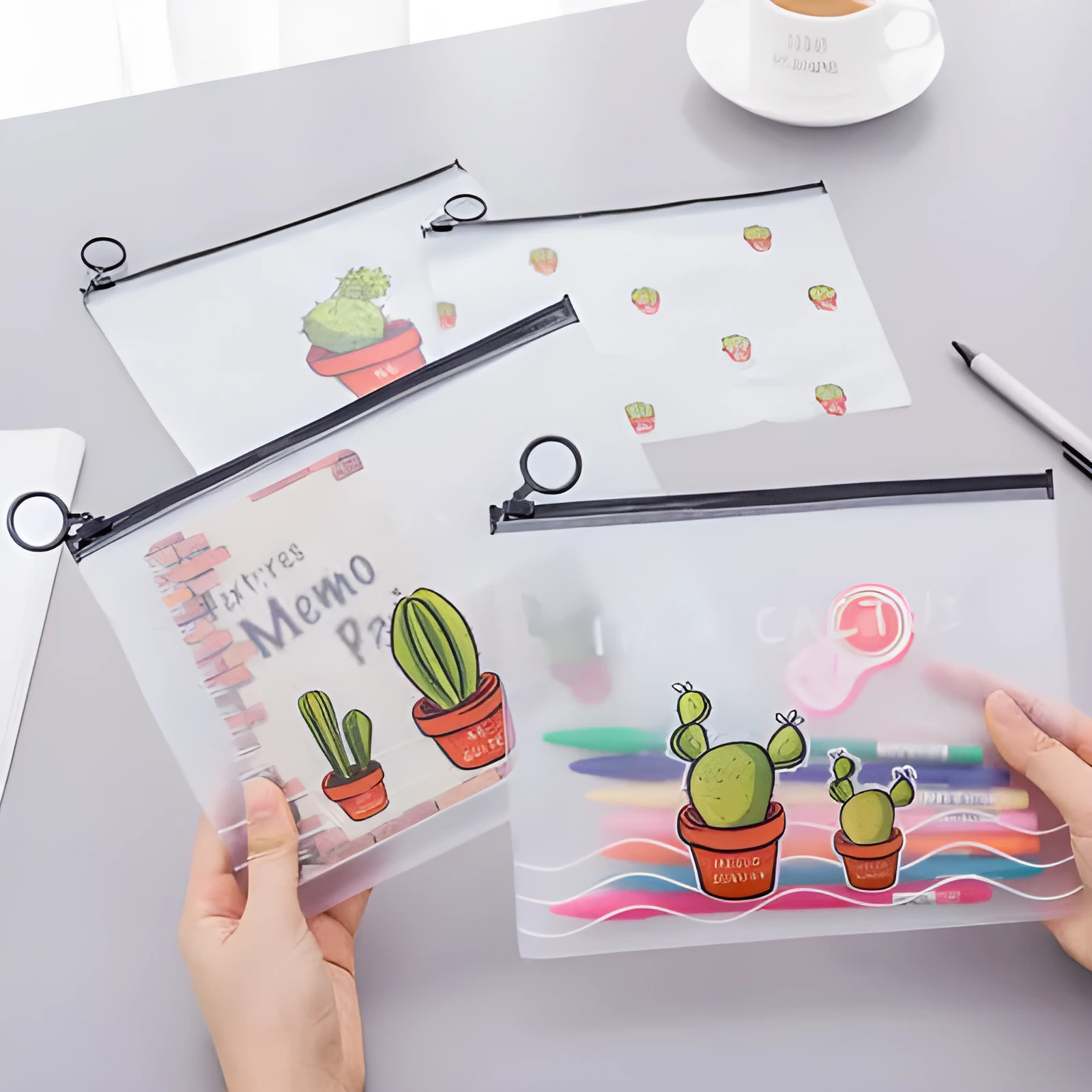 PVC pencil case with sealed closure, cactus print, 17.1x21.2cm, on a desk with stationery