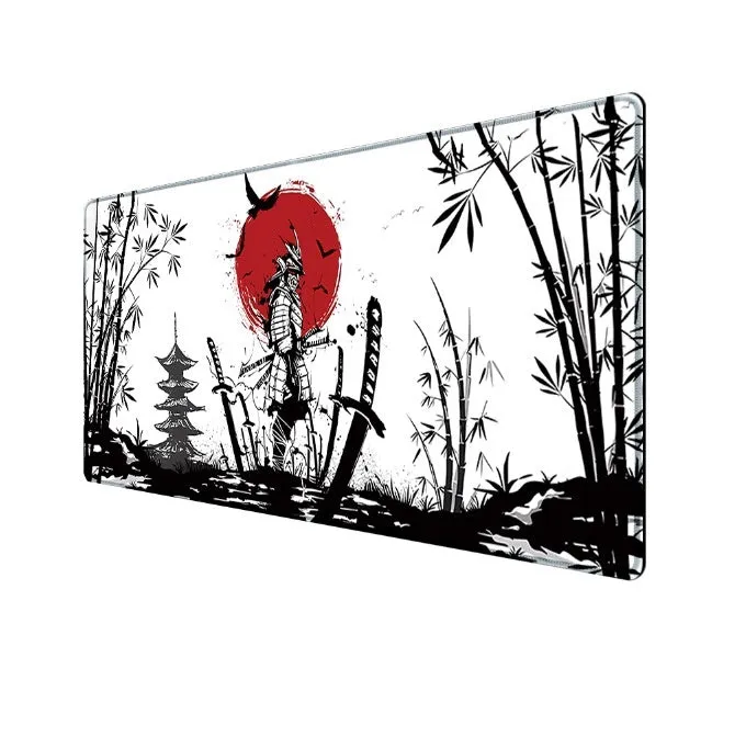 Large black gaming mouse pad with Japanese samurai warrior print and non-slip rubber base on a wooden desk.